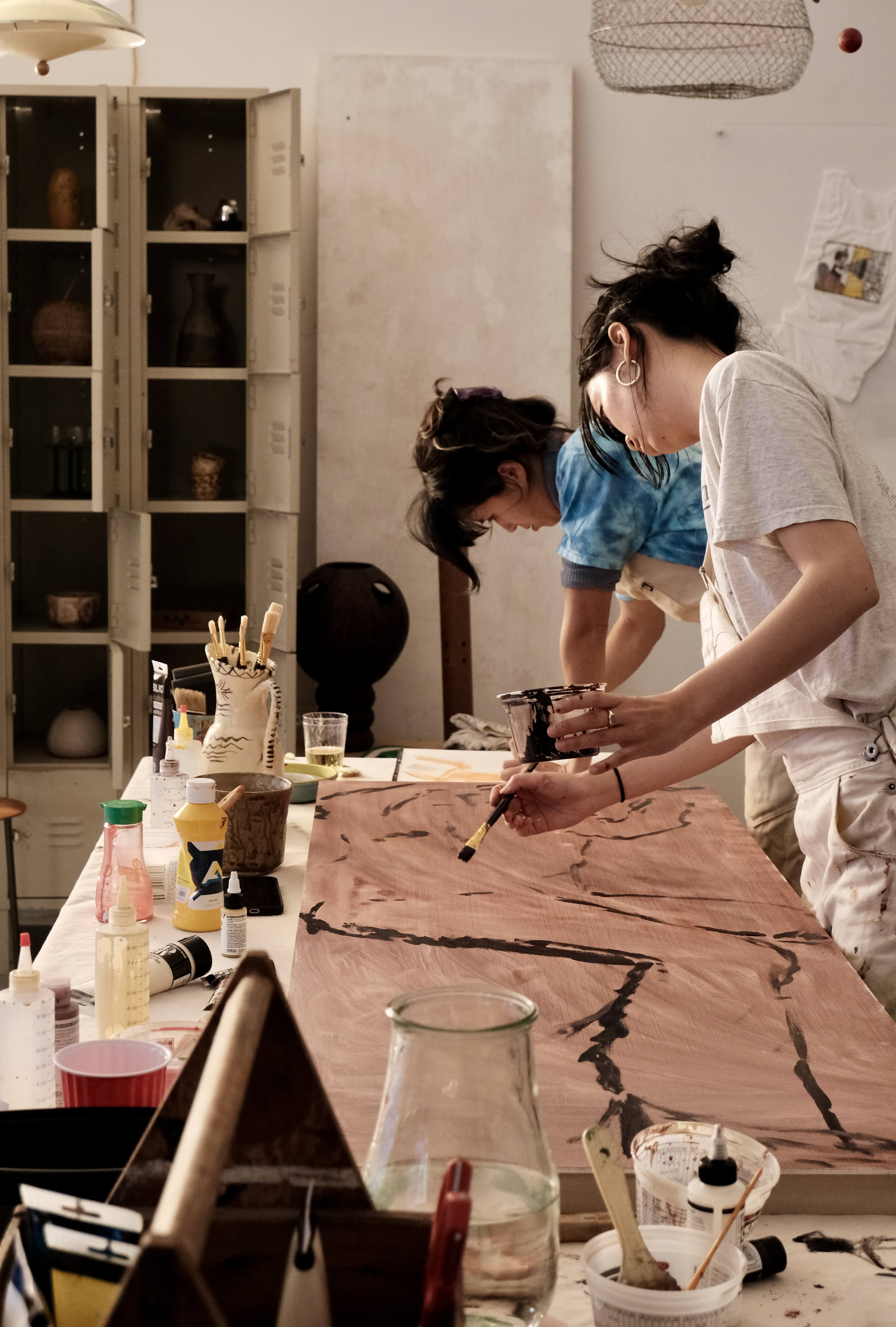 Two artists working together in a studio
