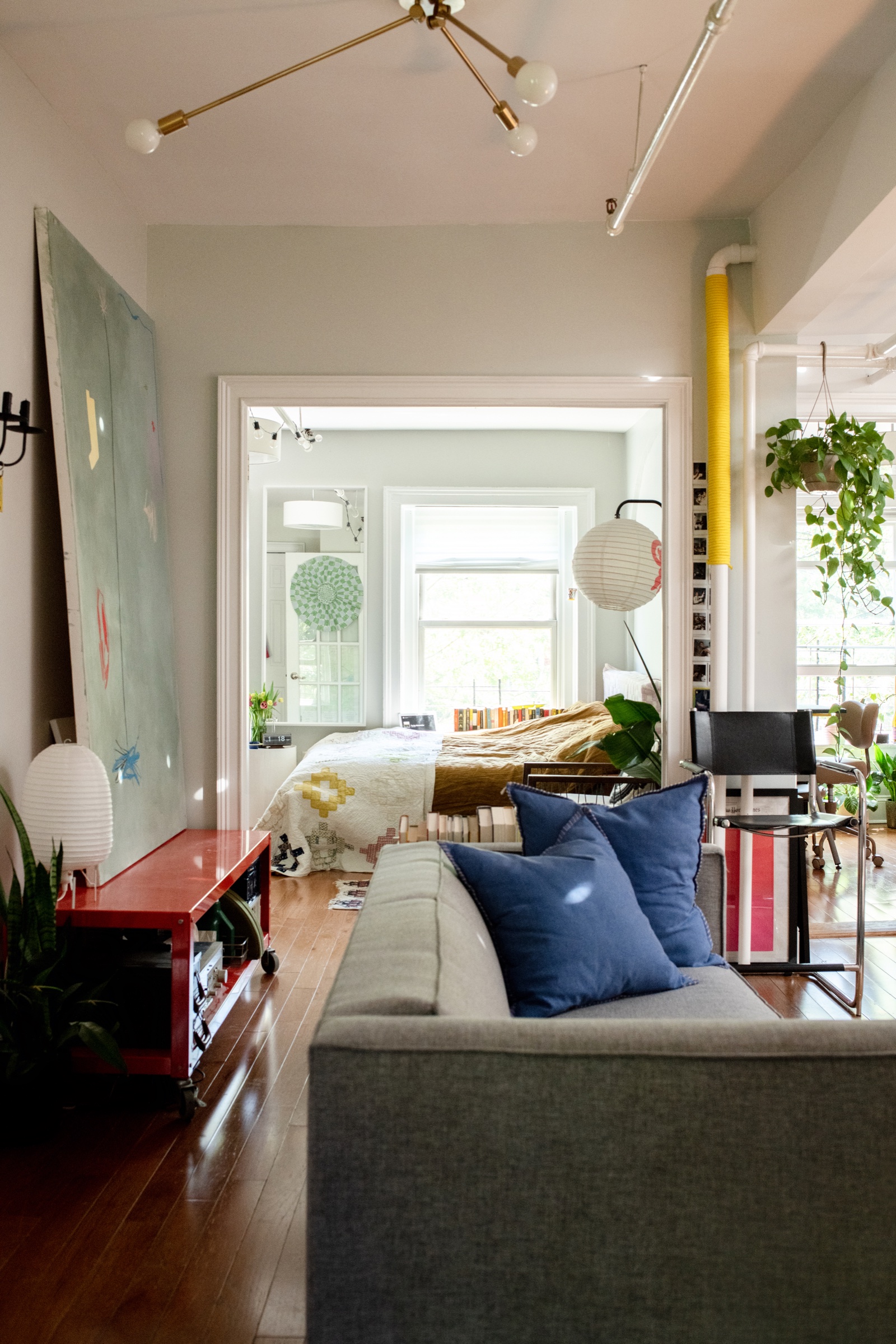 A colorful living space opening into a bedroom