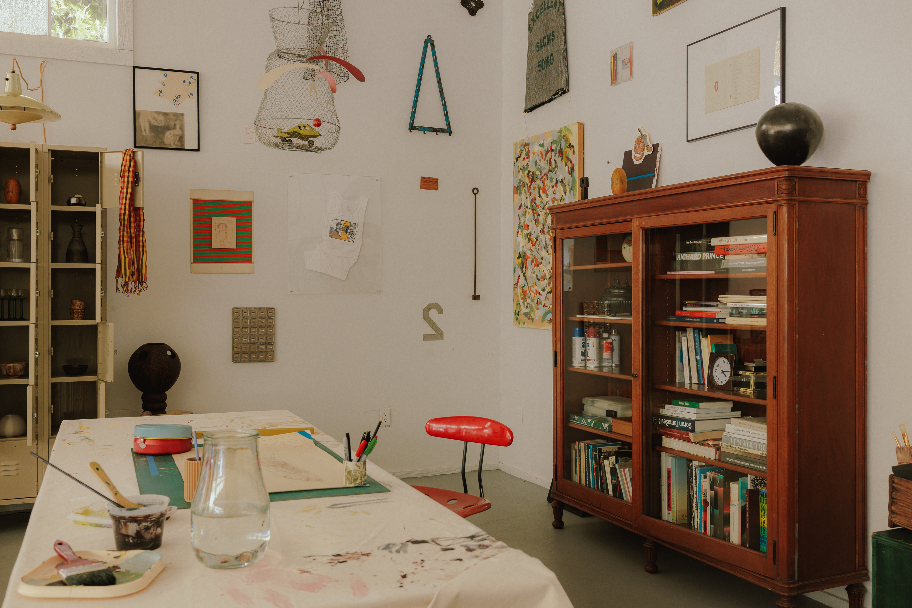 The Things in a Room studio with artwork, collected objects, and a wooden cabinet
